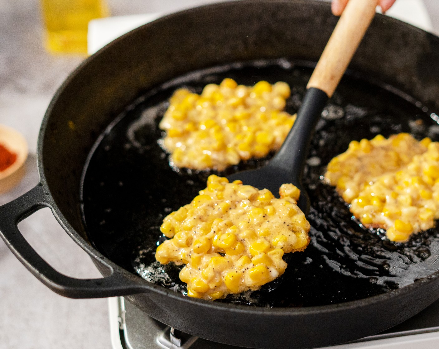 step 3 Heat Cooking Oil (as needed) over medium-high heat in the skillet, the oil should cover the bottom of the skillet. Drop spoonfuls of batter onto the pan, and cook for 1-2 minutes.