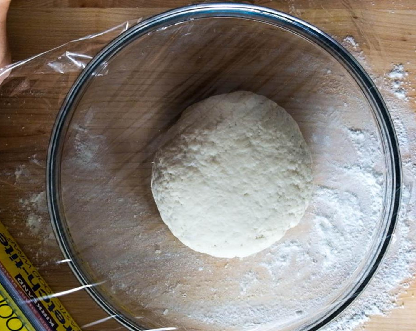 step 2 Add Cold Water (1/4 cup), 1 tablespoon at a time, and keep stirring until there is little or no dry flour on the bottom of the bowl. Dust both hands with a thin layer of flour. Press and work the dough flakes together by hand to form a dough ball.