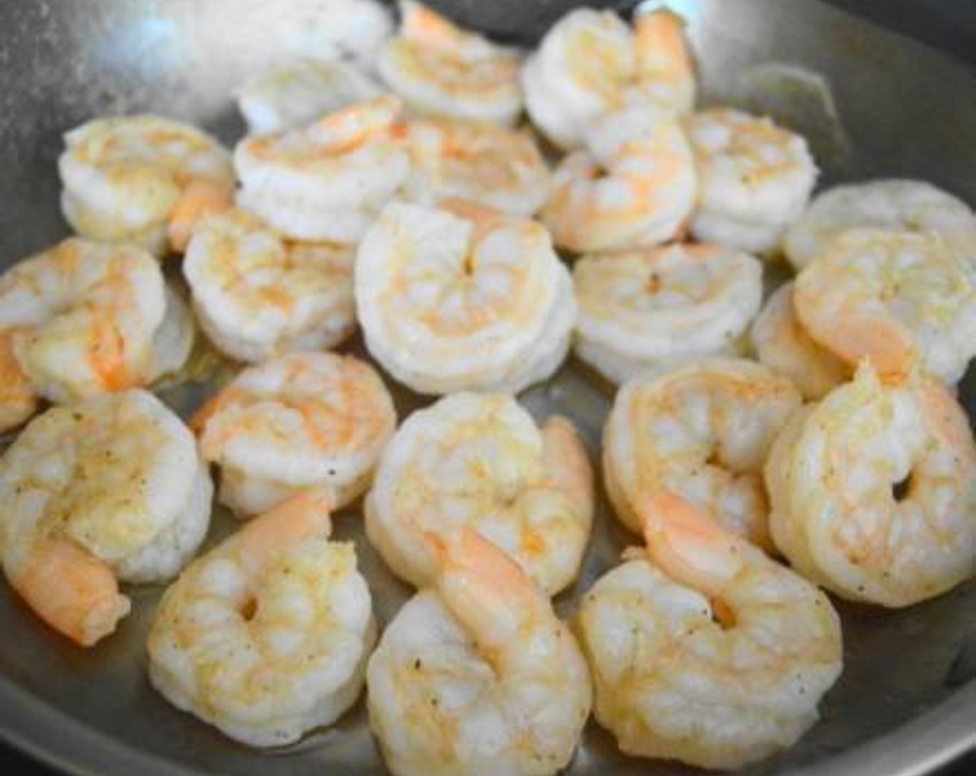 step 5 Cook the Shrimp (2 lb) in the oil just until they are pink and opaque on both sides. It should take about 4-5 minutes. While they cook, season them with the Salt (1 pinch) and Chili Powder (1 pinch) powder. Take the pan off of the heat.