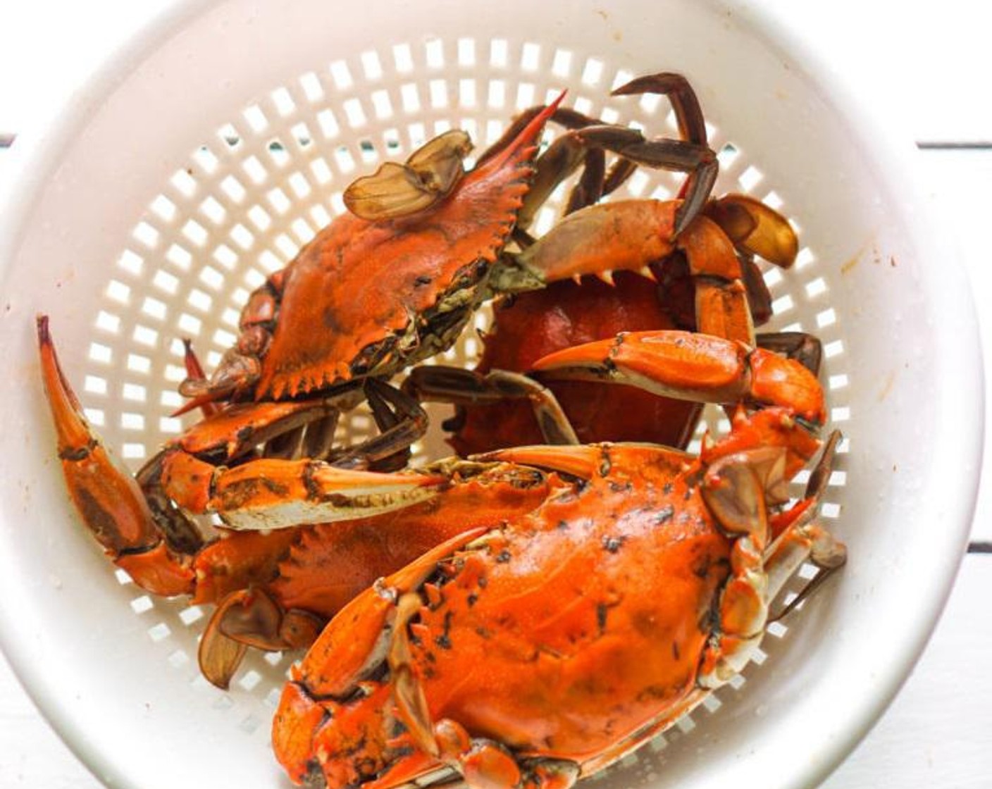 step 1 Rinse and clean the Whole Crabs (4). Cut the crab  in half or quarters, depending on the size, with the legs still attached.