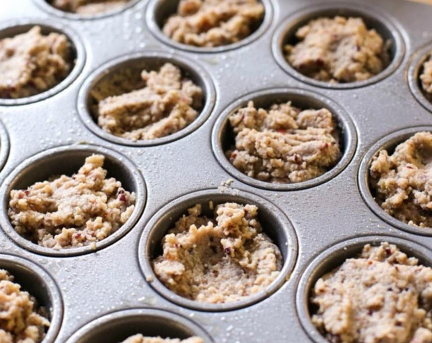 step 5 Lightly coat 2 non-stick mini muffin tins with a light dusting of coconut oil, if needed. Place about 2 Tbsp of mixture into each muffin cup.