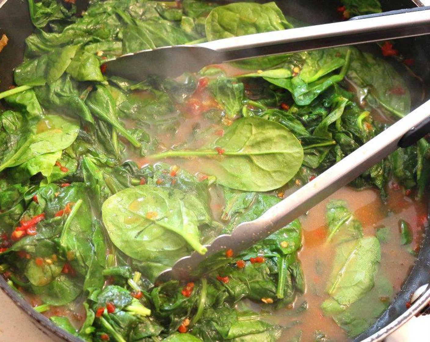 step 5 Add Chicken Stock (1/3 cup) and Spinach Leaves (11 1/3 cups) to the pan, season with Kosher Salt (to taste) and simmer briefly then remove from heat.