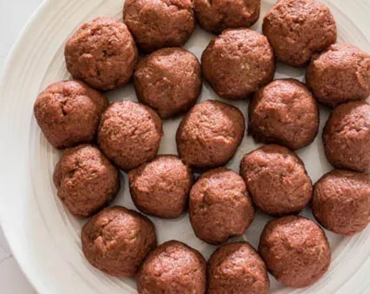 step 3 Use your hands to form the ground beef mixture into meatballs. Each meatball should be about one heaping tablespoon in size.