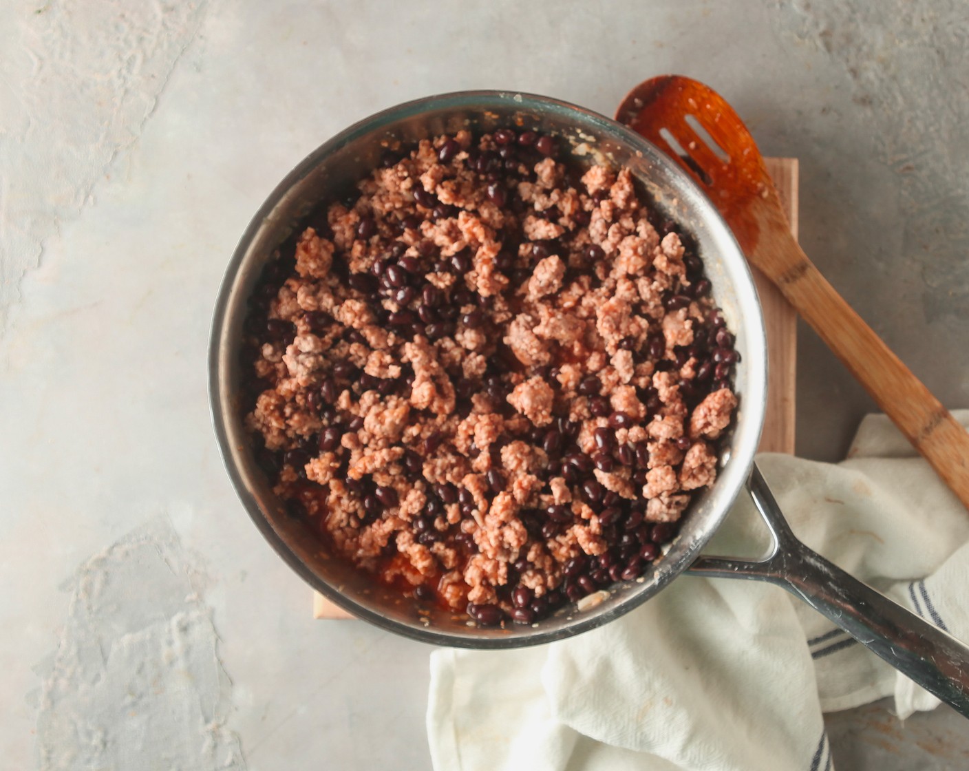 step 5 Stir in the Chili Powder (1 Tbsp), Salt (1/2 tsp), Black Beans (1 can), Enchilada Sauce (1 can), and Shredded Mexican Cheese Blend (1/2 pckg).