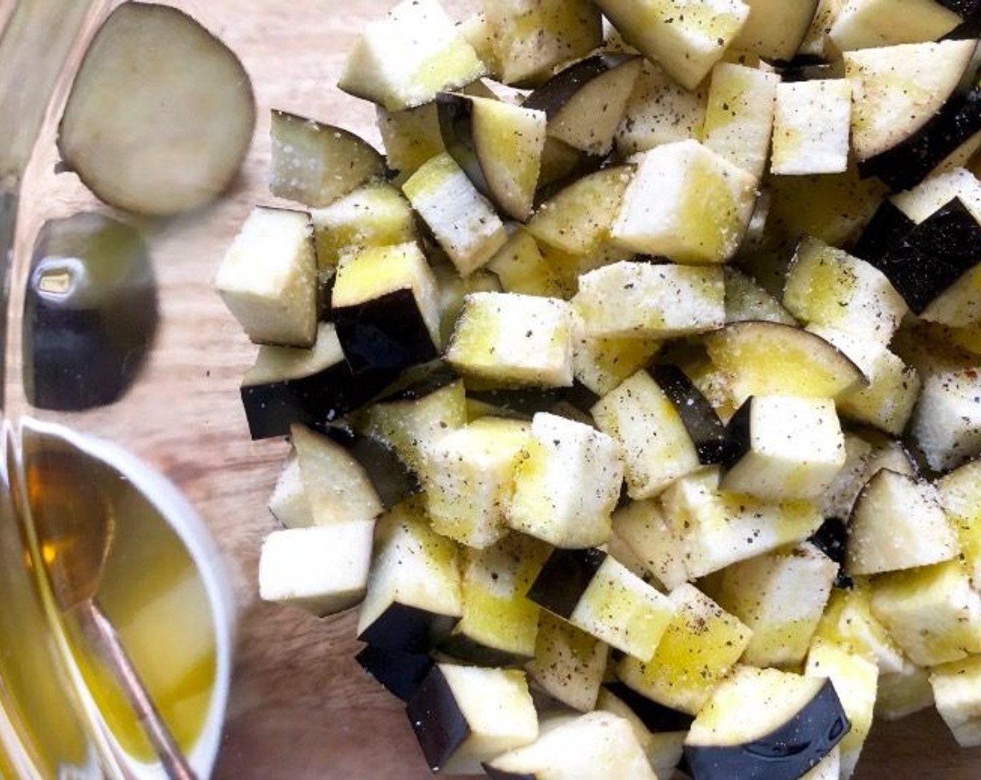 step 2 Place the Eggplants (5 2/3 cups) in a large bowl. Season with Kosher Salt (1 tsp) and Freshly Ground Black Pepper (1/2 tsp). Drizzle with Extra-Virgin Olive Oil (2 Tbsp). Using your hands, toss to coat.