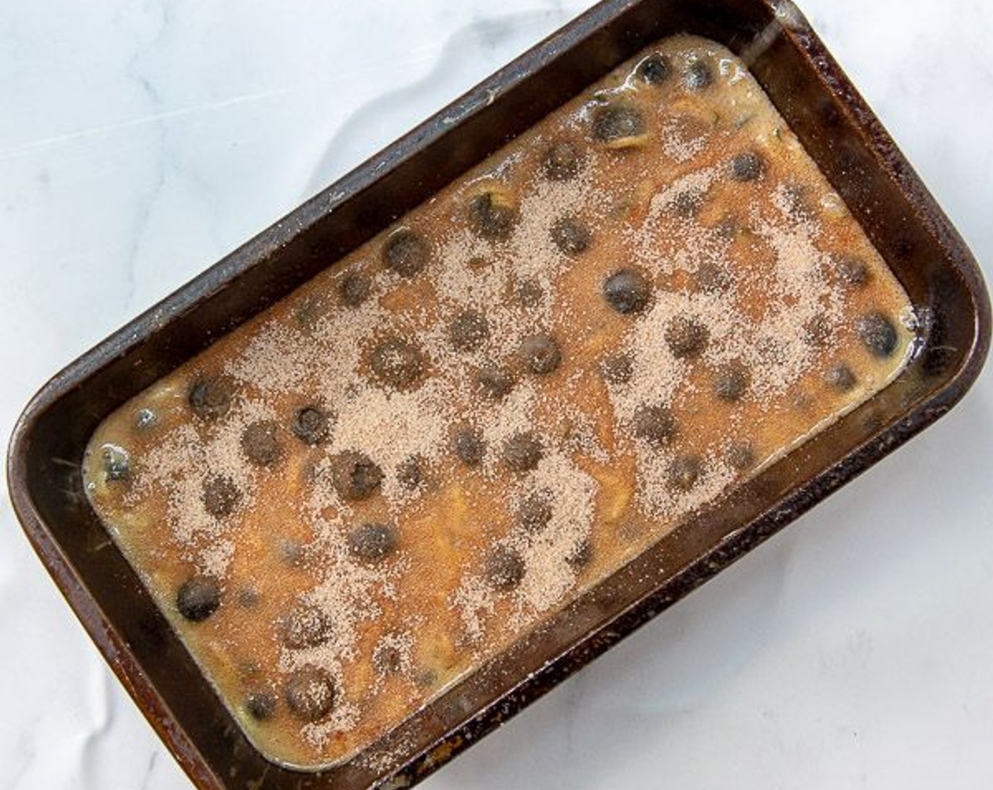 step 5 Combine the Granulated Sugar (2 Tbsp) and Simply Organic Cinnamon, Ground (1/2 tsp) and sprinkle over the top of the batter in the 2 pans.