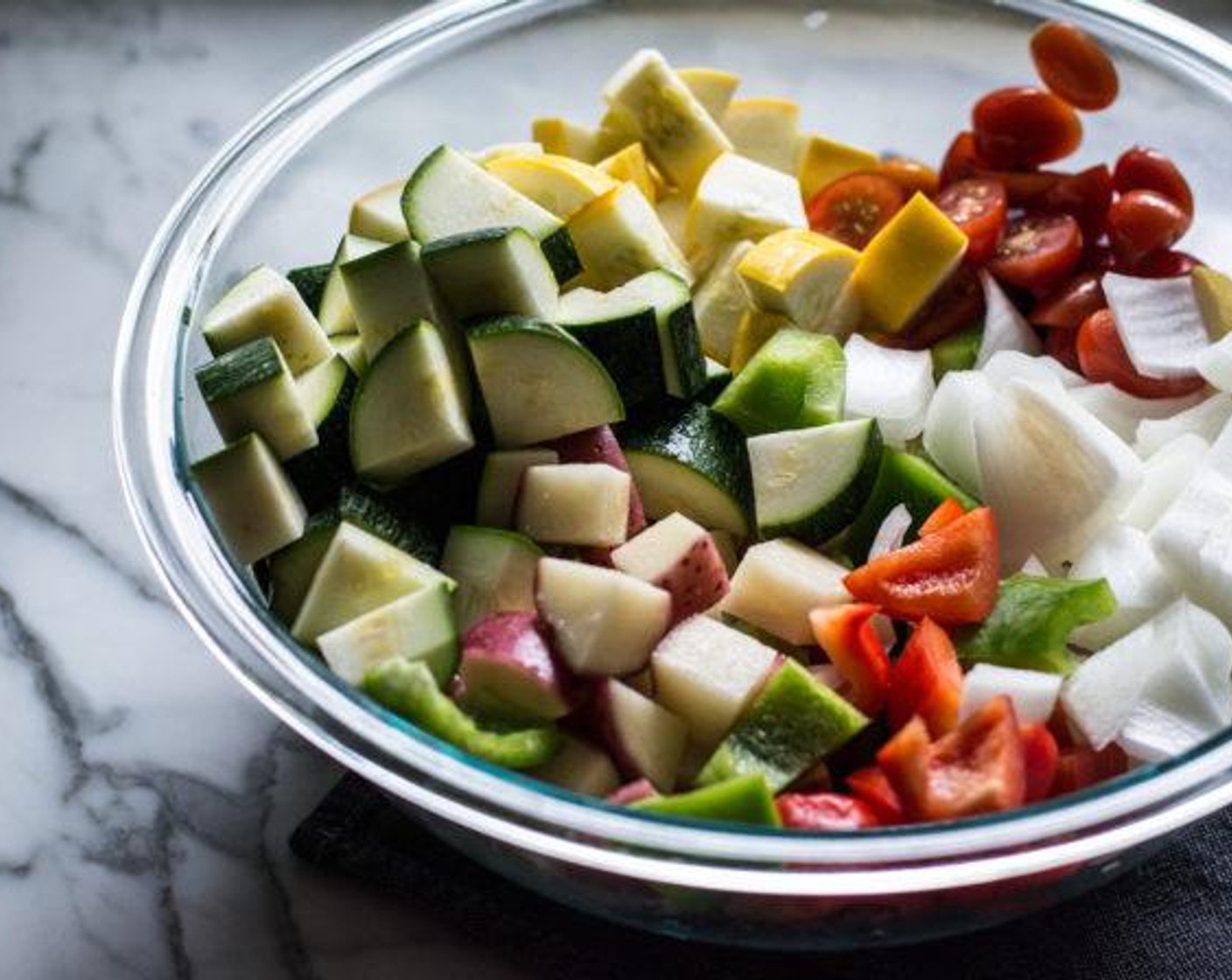 step 2 Layer Red Potatoes (3), Zucchini (1), yellow squash, Sweet Onion (1), Bell Pepper (1), Cherry Tomatoes (20), and Baby Bella Mushroom (1 cup) on two medium baking sheets.