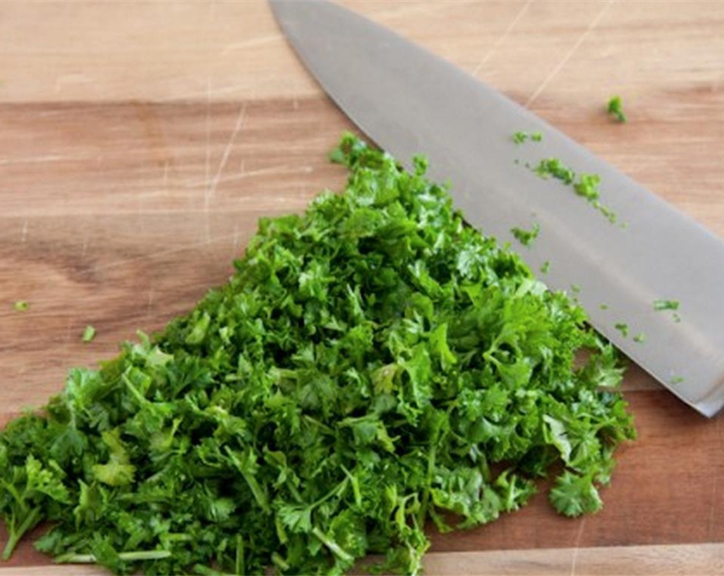 step 12 For the Salsa Verde: Finely chop the Italian Flat-Leaf Parsley (1 bunch) and combine with pickled shallots, Extra-Virgin Olive Oil (3/4 cup), and Salt (1 tsp) in a bowl.