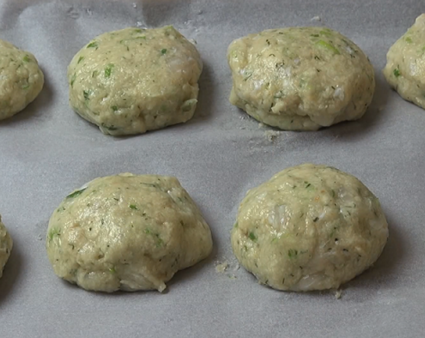 step 2 Using wet hands, divide the mixture into 8 patties and place on a tray lined with non-stick baking paper. Cover the cakes with plastic wrap and chill in the fridge for half an hour.