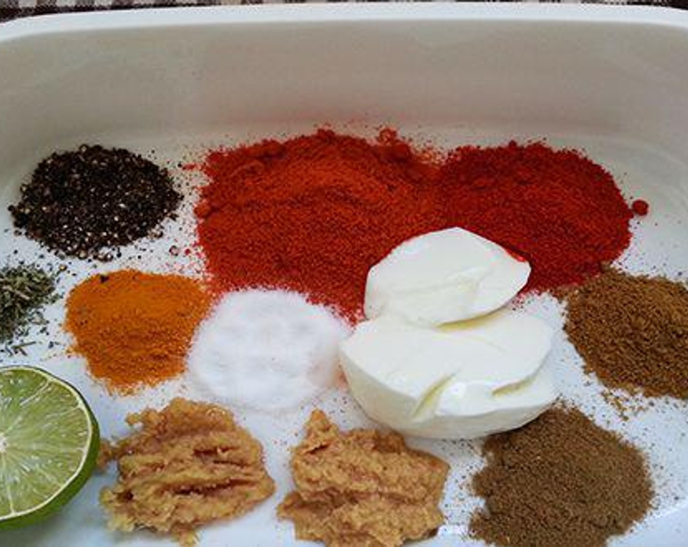 step 2 To a bowl add Thick Yogurt (2 Tbsp), Lime (1), Oil (2 Tbsp), Red Chili Powder (1 tsp), Kashmiri Red Chili Powder (1 tsp), Ginger Paste (1 tsp), Garlic Paste (1 tsp), Ground Turmeric (1/2 tsp), Garam Masala (1/2 tsp), Ground Cumin (1/2 tsp), Ground Black Pepper (1/4 tsp), Kasoori Methi Powder (1 pinch), and Salt (to taste) for marination. Combine everything well, if required add a table spoon of water.