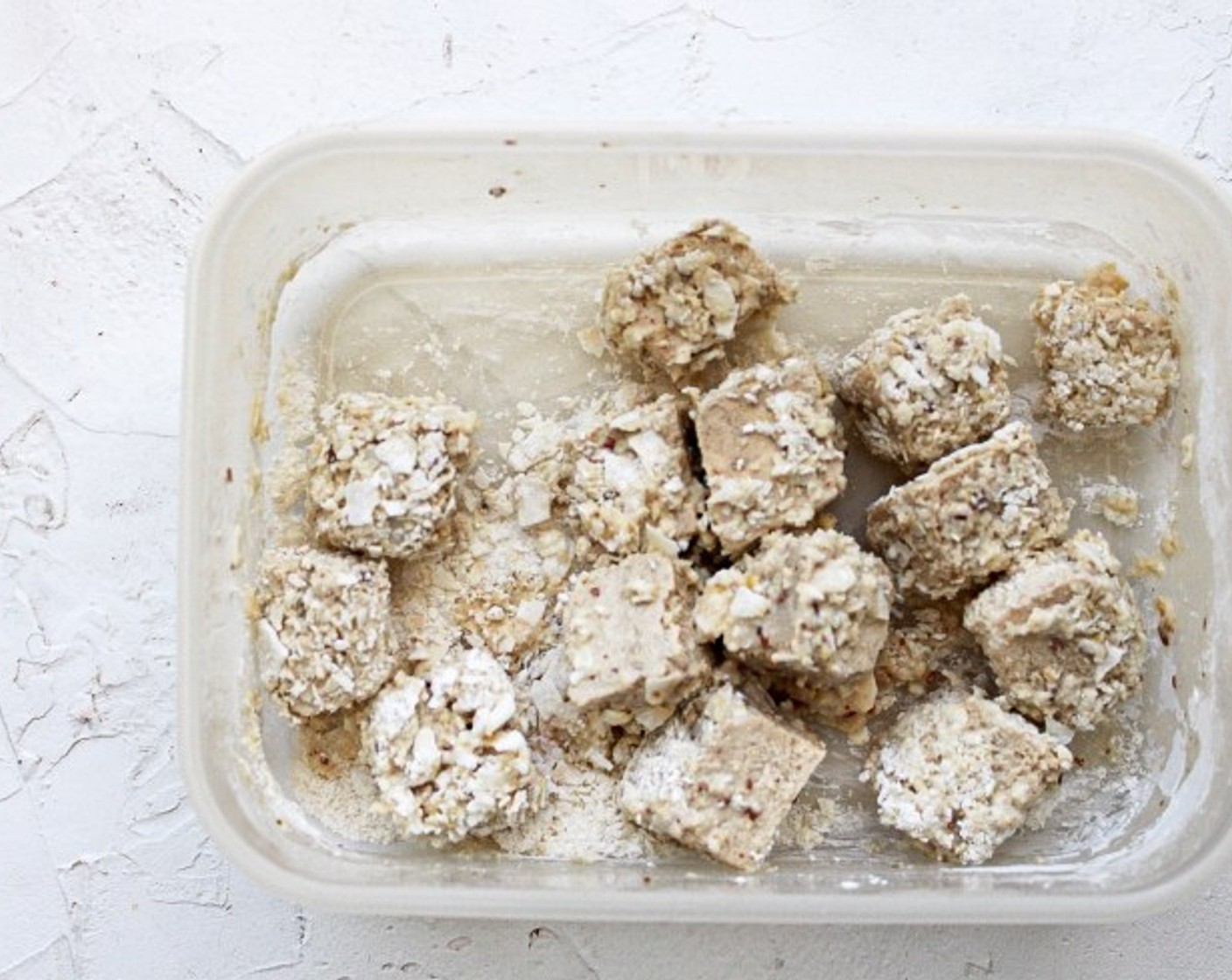 step 9 Place approx. 1/3 of the battered tofu into the bowl or Tupperware container with the coconut crust and gently shake until all sides are coated.