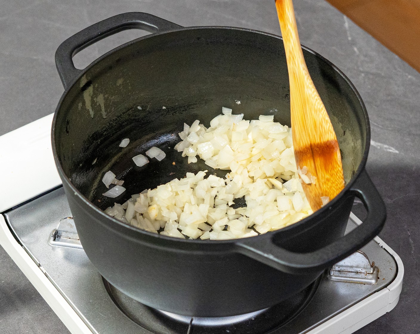 step 1 In a medium soup pot, heat the Olive Oil (2 Tbsp) over medium heat. Once hot add the Yellow Onion (1) and Garlic (2 cloves) and sauté until the onions have softened.