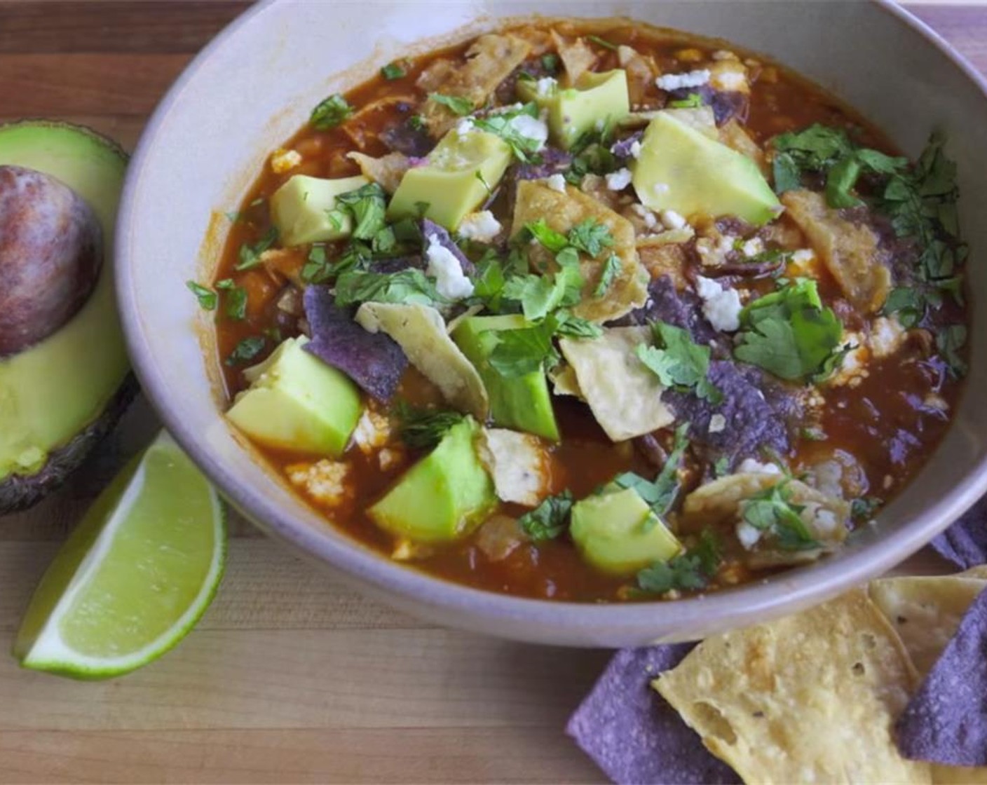 step 7 To serve, add some Tortilla Chips (to taste), Feta Cheese (to taste), Avocado (1), squeeze of a Lime (1), and Fresh Cilantro (1 handful).