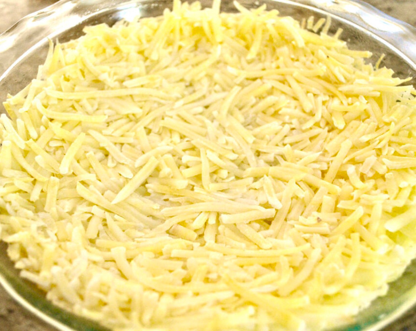 step 2 Press the Frozen Shredded Hash Browns (2 cups) into the pan to form a crust.