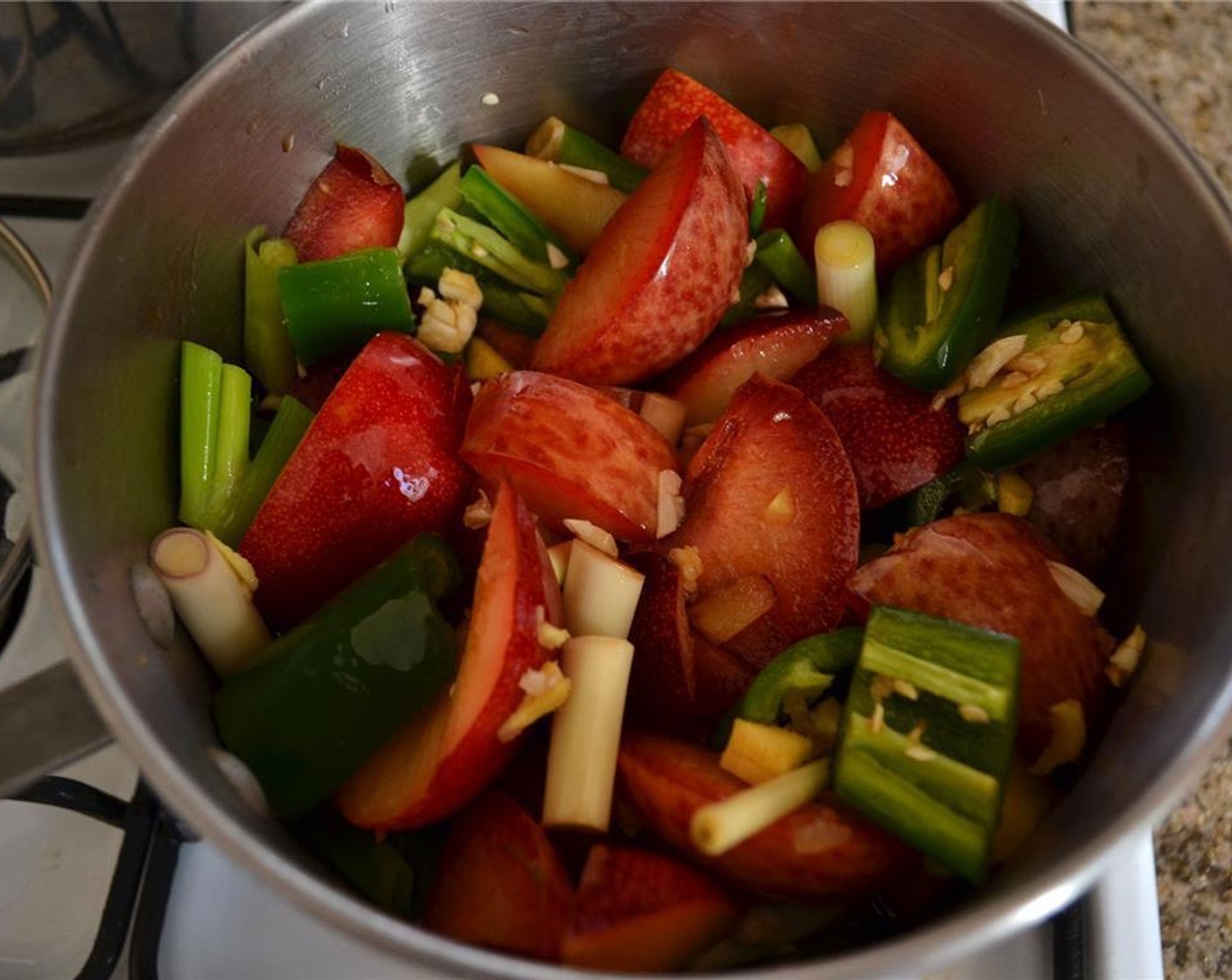 step 6 Combine the plums, ginger, lemongrass, chili pepper, scallion, Garlic (2 cloves), Soy Sauce (1/4 cup), Sweet Soy Sauce (1/4 cup), Honey (1/4 cup), Rice Vinegar (2 Tbsp), juice from the Lemon (1/2), and Water (1 cup) in a heavy saucepan and bring to a rolling boil over medium heat.