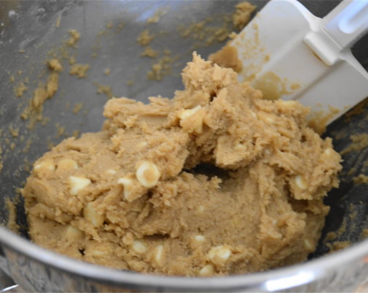 step 5 Switch to a rubber spatula and gently fold in the White Chocolate Chips (1 cup). In a small bowl, stir together Granulated Sugar (2 Tbsp) and Ground Cinnamon (1/2 Tbsp) for coating.