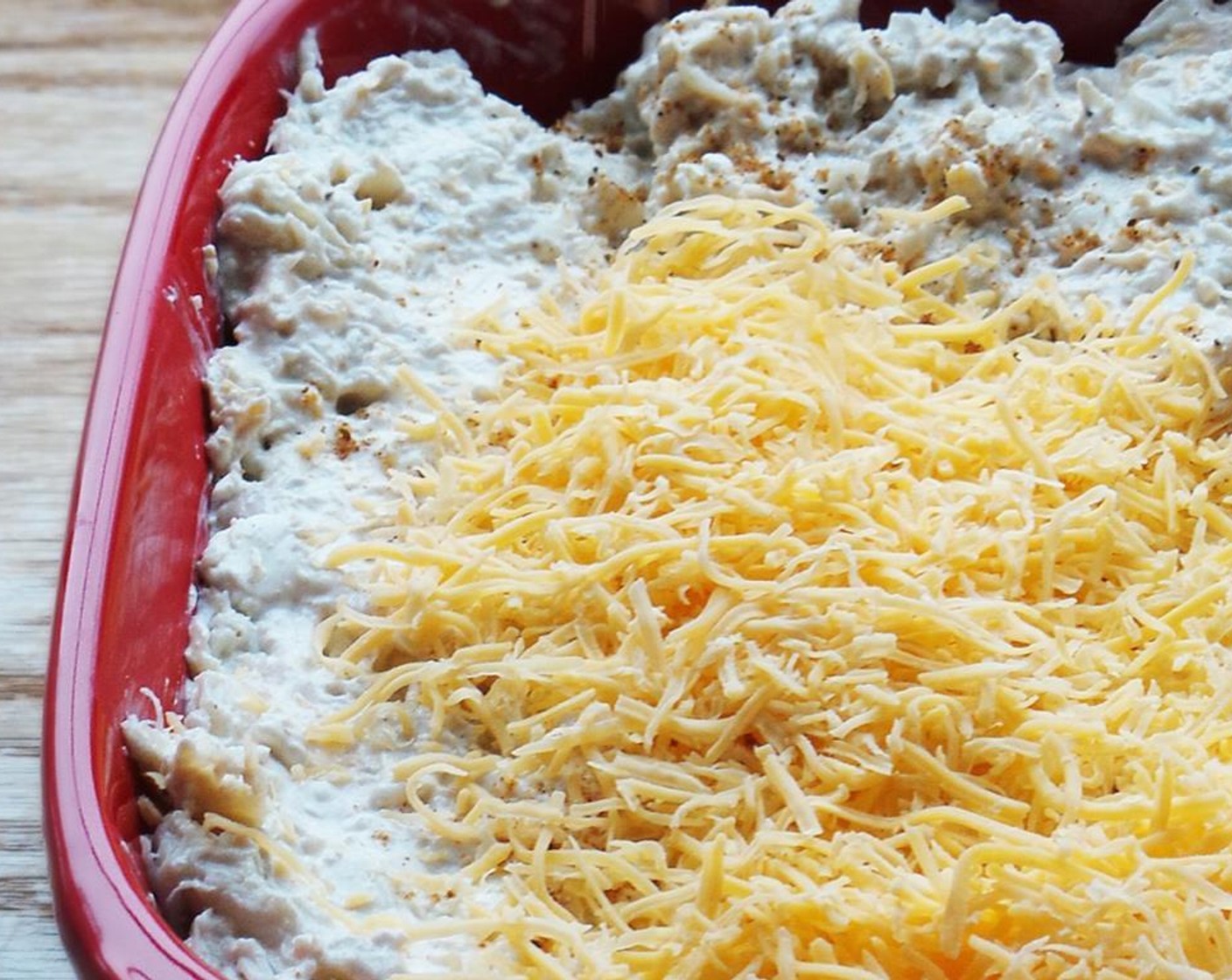 step 3 Slowly add the Old Bay® Seasoning (1/2 Tbsp) until desired taste is achieved. Pick through the Lump Crab Meat (1 lb) for shells and gently fold into the mix. Add to a baking dish and sprinkle remaining Shredded Cheddar Cheese (1/2 cup) over top.