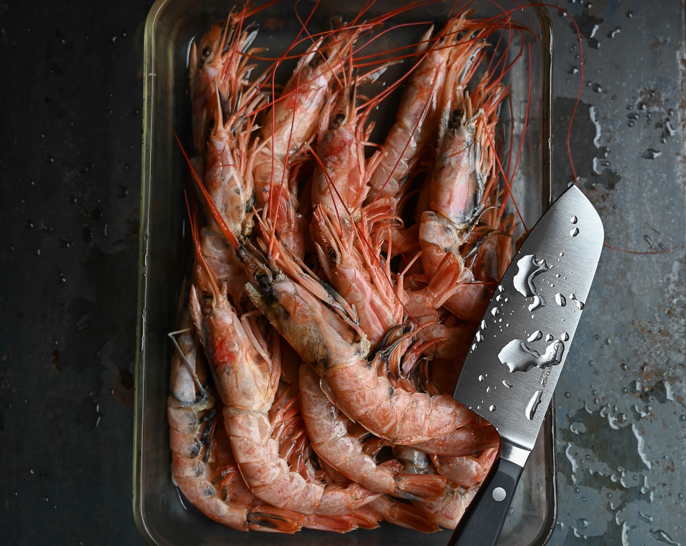step 1 To devein Prawns (2.2 lb) use a knife to slice along the backbone of the prawn. Pull out the alimentary canal and discard.