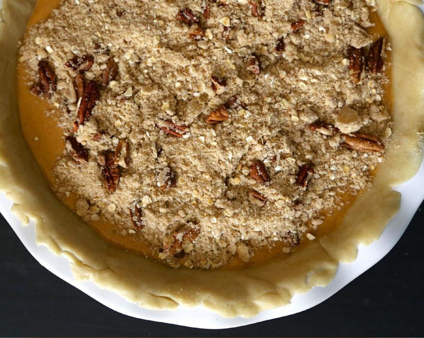 step 4 For the streusel: Combine All-Purpose Flour (40 g), Dark Brown Sugar (75 g), Oats (4 Tbsp), Pecans (4 Tbsp), Ground Cinnamon (1/2 tsp), Ground Ginger (1/8 tsp), Unsalted Butter (2 Tbsp), and Water (2 tsp) in a bowl, making sure the butter and flour have been completely combined.