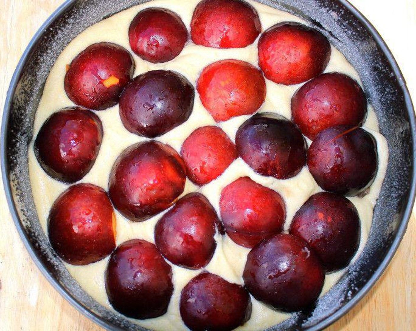 step 5 Top the batter with the Black Plums (12), skin side up, and sprinkle lightly with sugar and Ground Cinnamon (to taste). Drizzle with Lemon Juice (to taste).