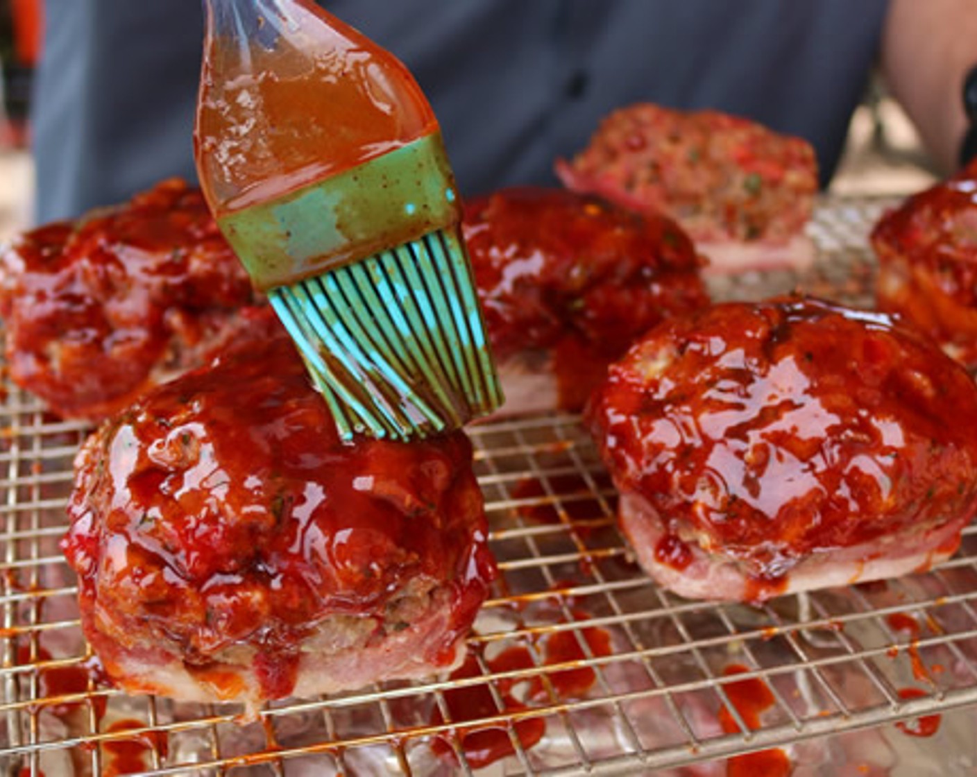 step 8 Carefully remove each mini meat loaf from pan and place on wire rack. Glaze with warm BBQ Glaze and return to the smoker for 15 minutes or until internal temp reaches 165 degrees F (75 degrees C) minimum.