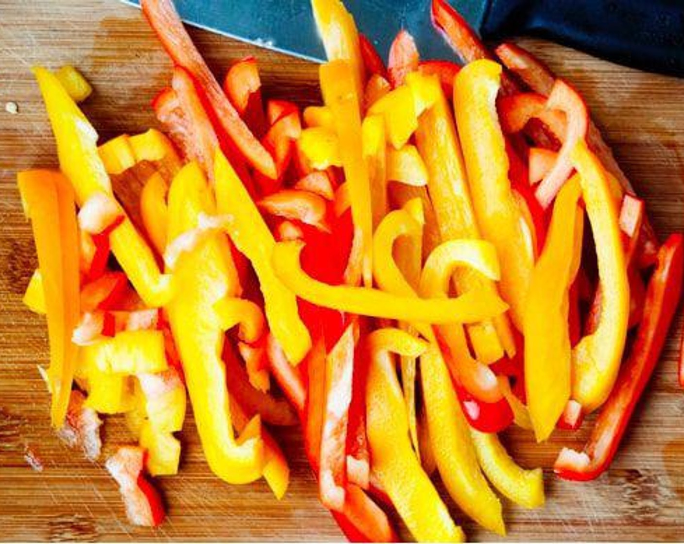 step 1 Wash the Yellow Bell Pepper (1) and Red Bell Pepper (1). Cut the peppers into strips.