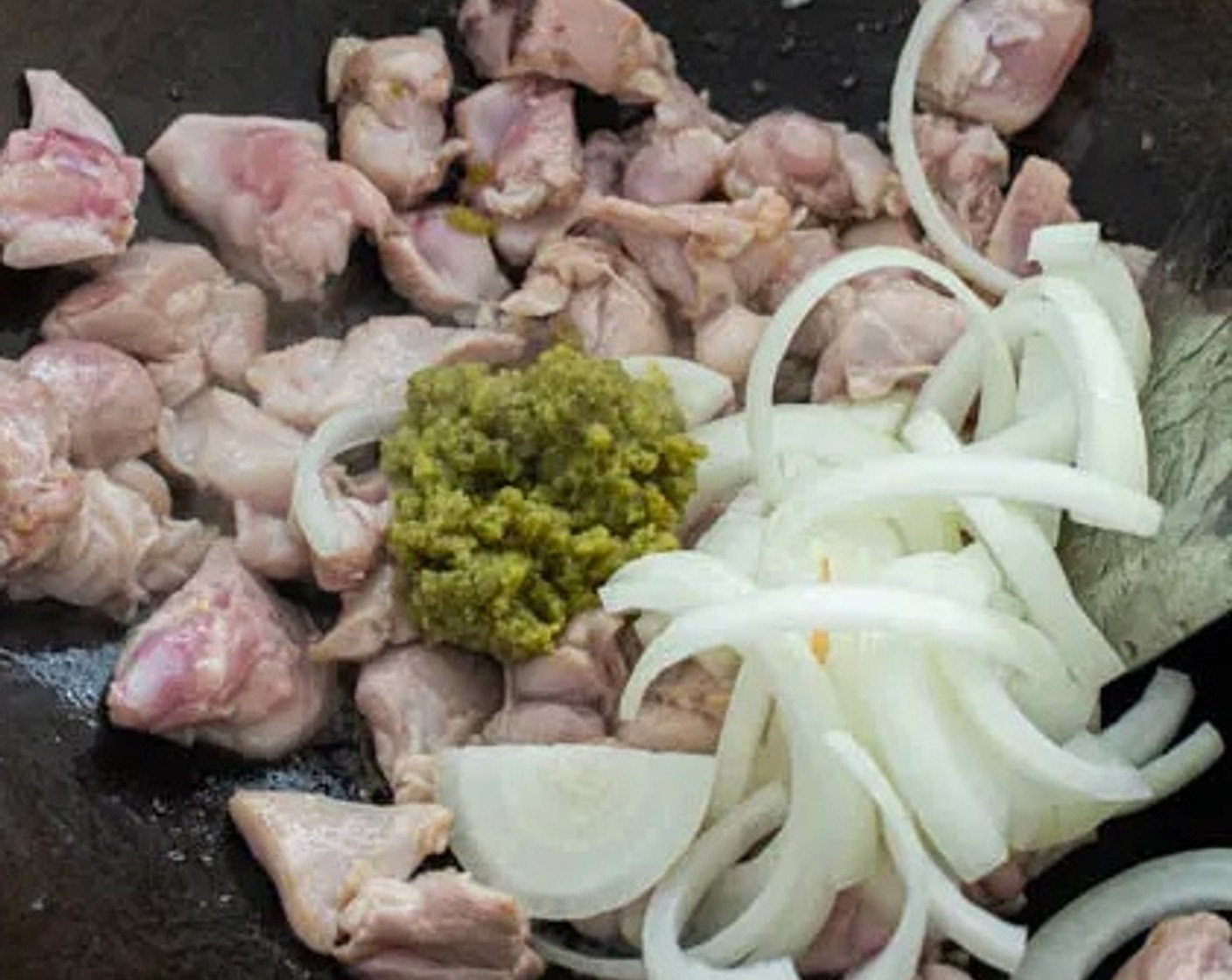 step 4 When the chicken is partially cooked, add Onion (1) and Thai Green Curry Paste (2 Tbsp). Stir for 1 minute.