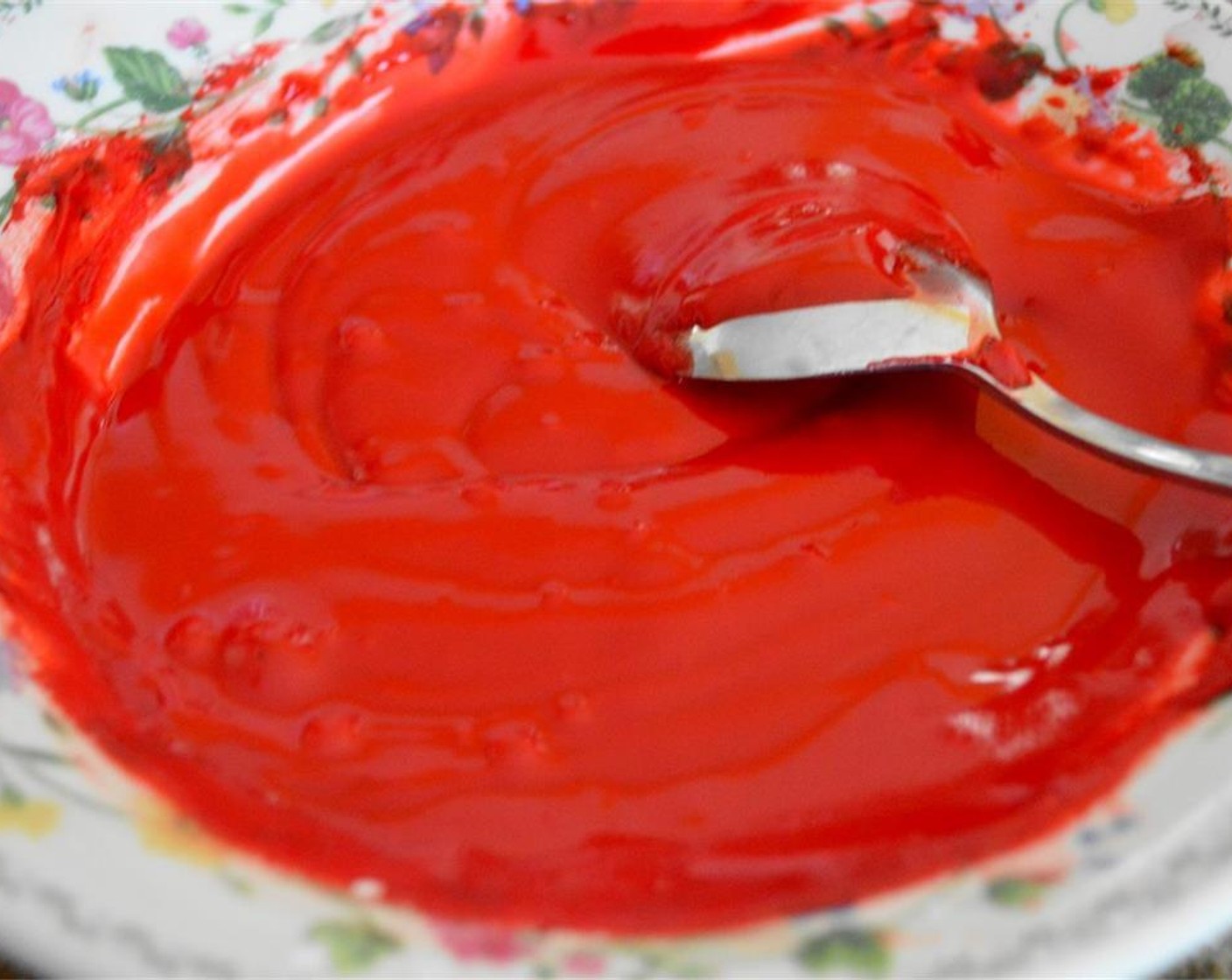 step 8 Prepare the glaze by stirring Powdered Confectioners Sugar (1 1/2 cups), Red Food Coloring (to taste), Rose Water (1 tsp), and Vanilla Extract (1 tsp) together until it becomes a thick frosting. Thin it out and make it glossy with dashes of filtered Water (2 dashes). Set the glaze aside.