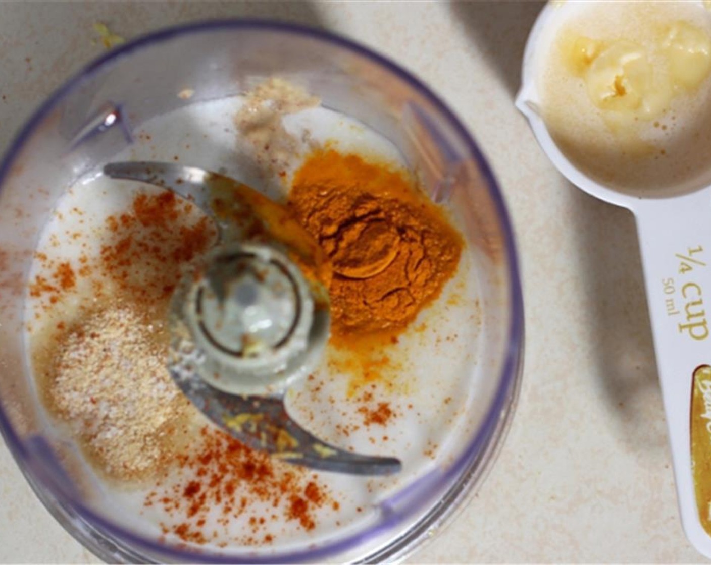 step 1 Blend Light Coconut Milk (3/4 cup), Dijon Mustard (1/2 Tbsp), Lemon (1), McCormick® Garlic Powder (3/4 tsp), Ground Turmeric (1/2 tsp), Vegan Margarine (2 Tbsp), Nutritional Yeast (1 Tbsp), Cayenne Pepper (1 pinch), Salt (1 dash) and Tapioca Starch (1 Tbsp) in a food processor.