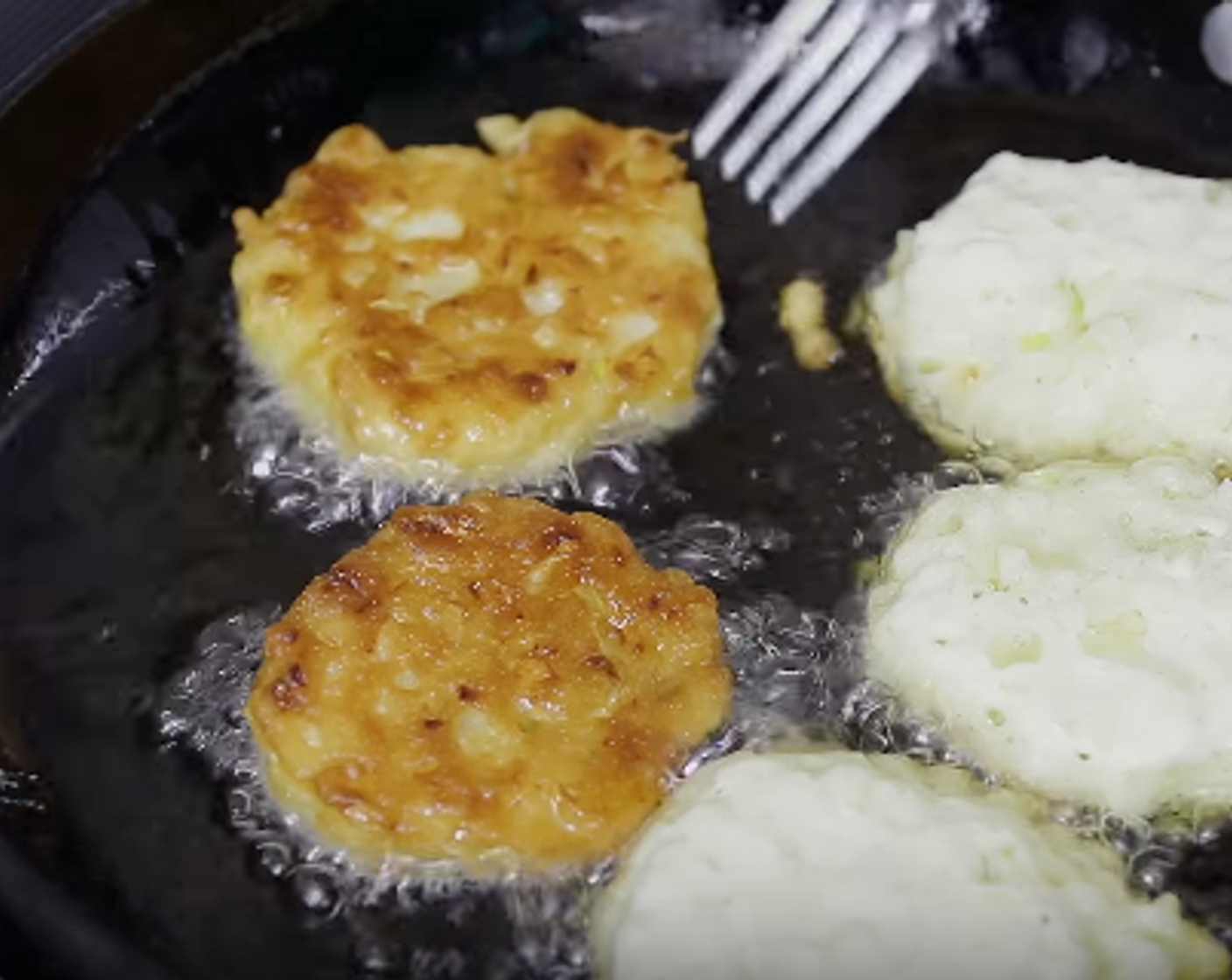 step 3 Heat 1/2 inch of Frying Oil (as needed) in a skillet over medium-high heat. Using a tablespoon, drop batter in hot oil, flatten ever so slightly. Fry for 3-4 minutes on each side or until brown and crisp. Drain on a paper towel.