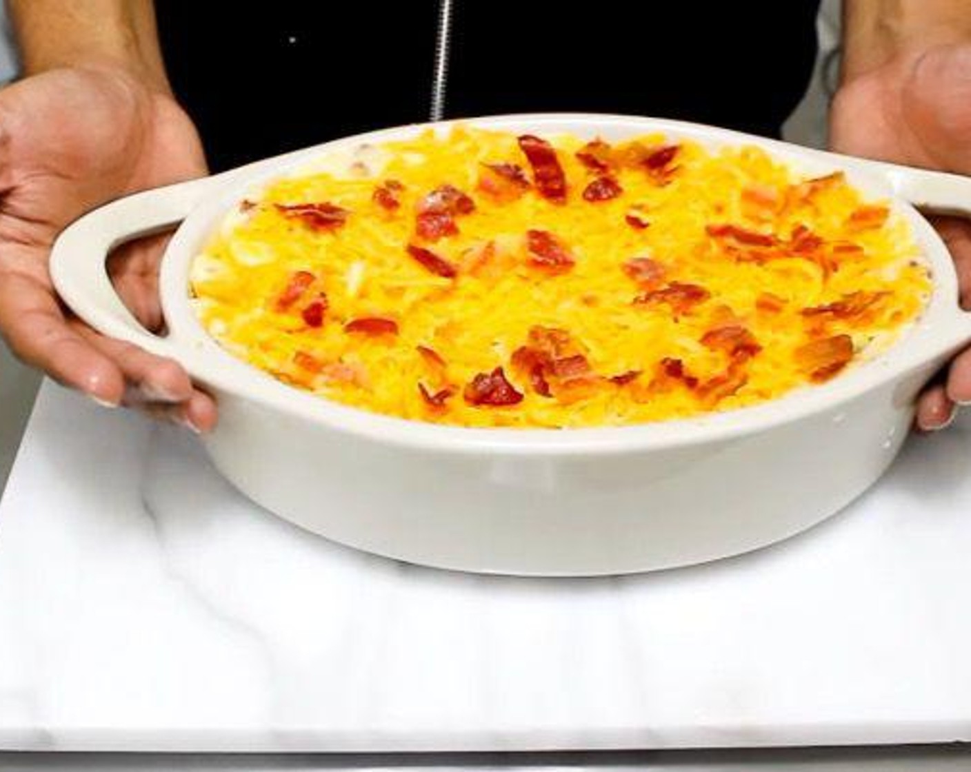 step 5 Transfer mixture to a baking pan and even out the surface. Top with extra cheese and bacon.