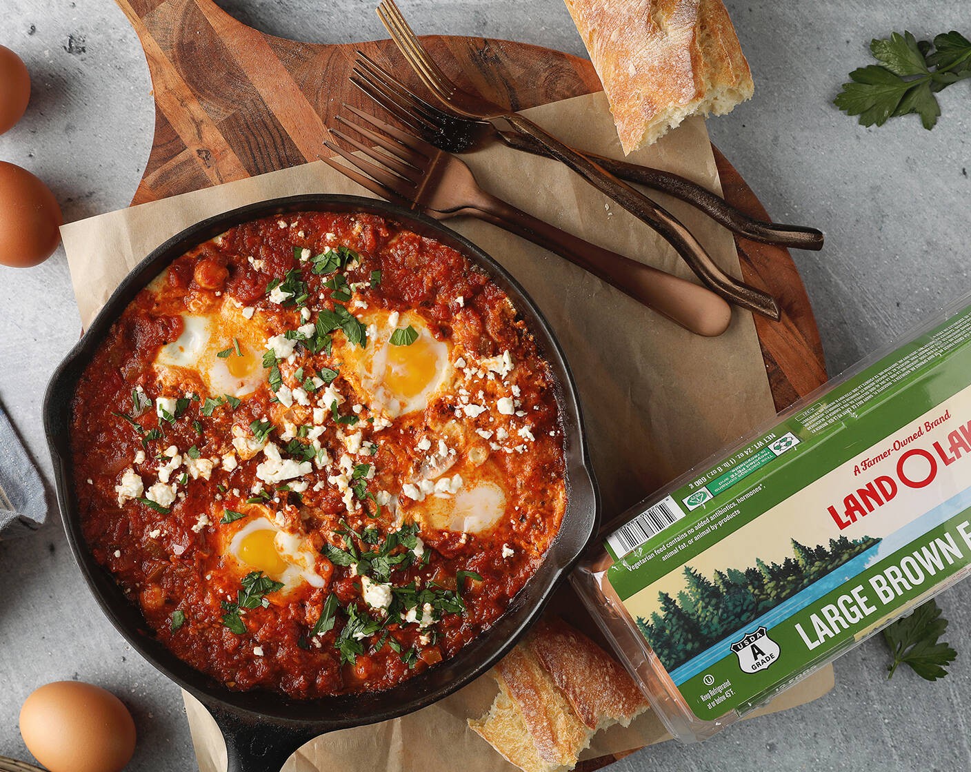 step 5 Crack 1 Land O Lakes® Large Brown Eggs (4) into each indent and cover the pan. Cook 5-7 minutes or until cooked to desired doneness. Remove from heat; sprinkle with Fresh Parsley (as needed) and Crumbled Feta Cheese (to taste).