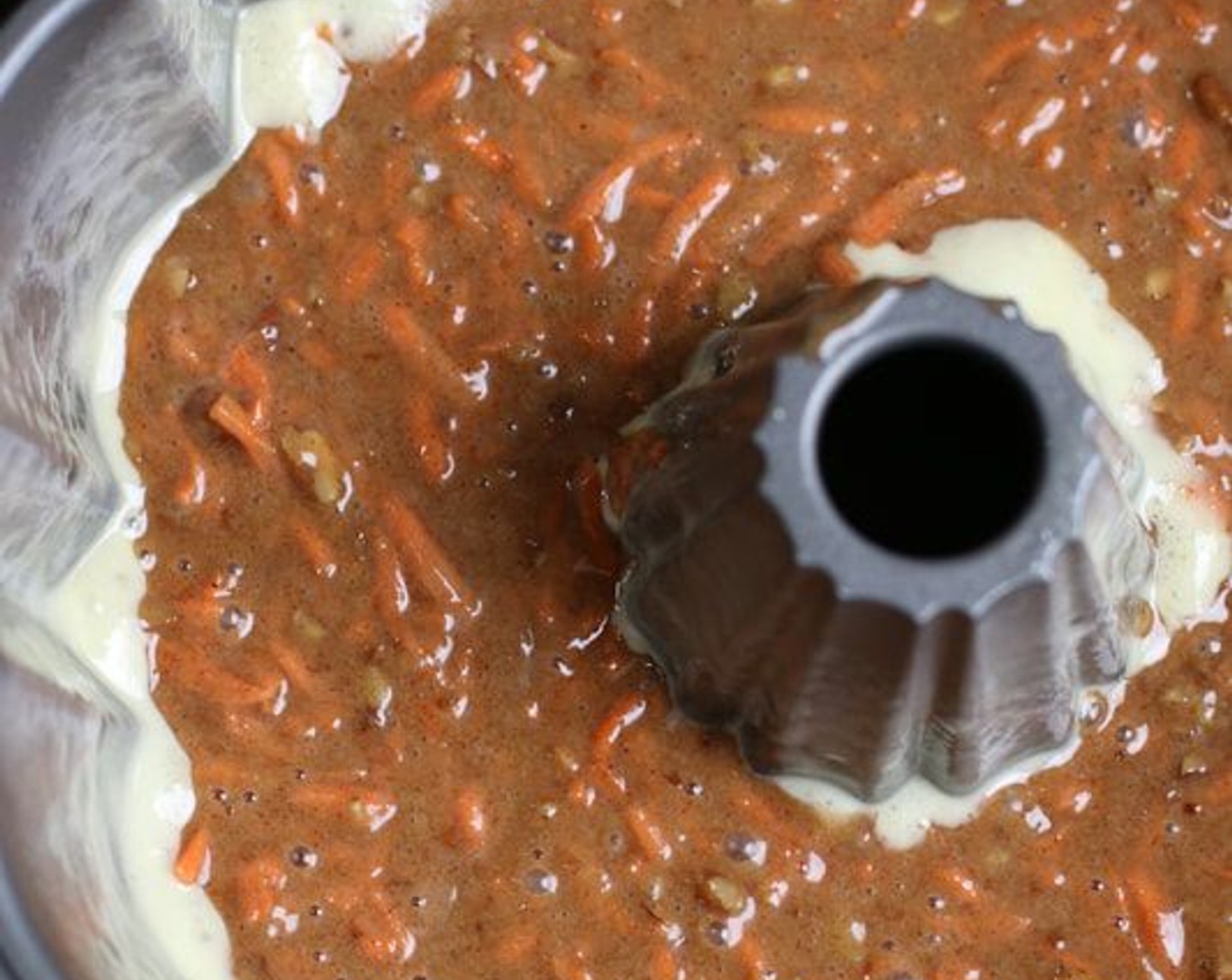 step 9 Pour 3 cups batter into prepared bundt pan. Spoon Cream Cheese Filling over batter and gently smooth, but do not touch the sides of the pan. Top with remaining batter.