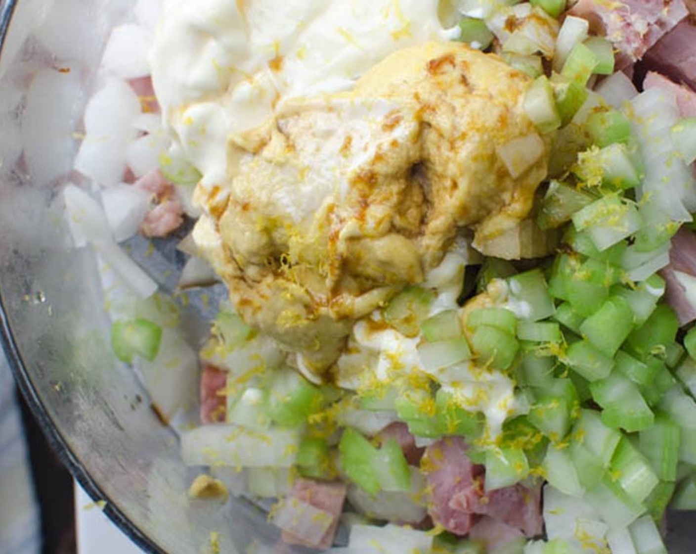 step 4 Add the ham, onion, celery, Dijon Mustard (2 Tbsp), Worcestershire Sauce (1 Tbsp), and Mayonnaise (1/3 cup) to the bowl of a food processor.