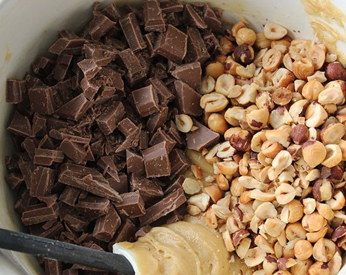 step 6 Add Milk Chocolate (2 bars), Semi-Sweet Baking Chocolate (2 bars), and hazelnuts and mix until just combined.