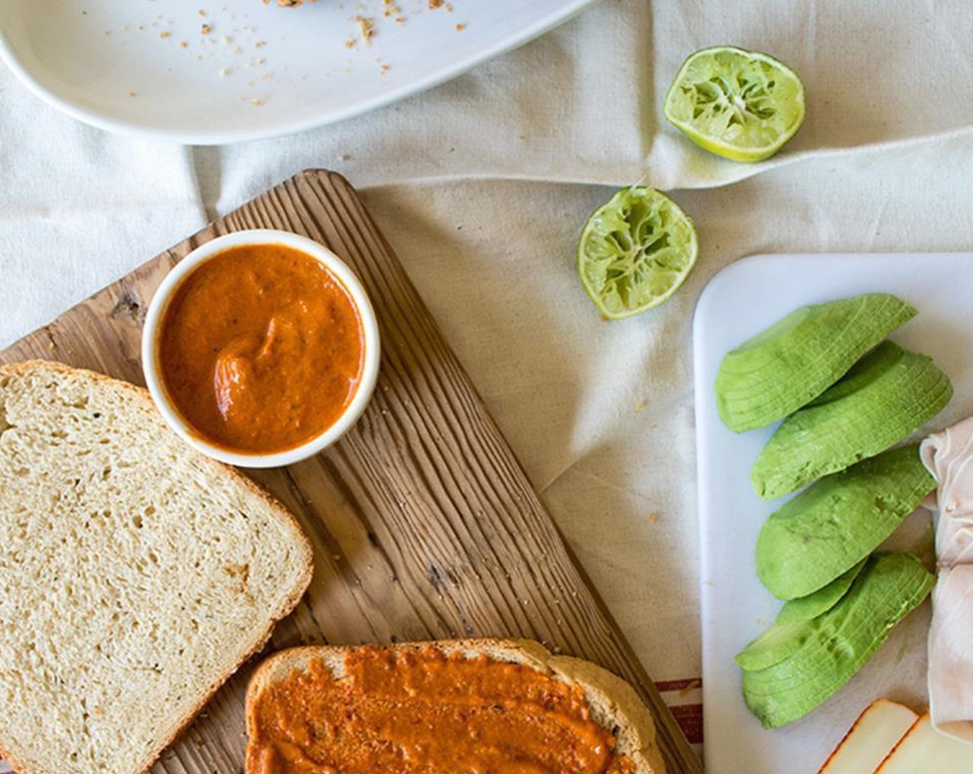 step 3 Add Harissa to cover one piece of French Bread (8 slices) for each sandwich. layer with Avocados (2), Deli Turkey (16 slices) and Muenster Cheese (4 slices).