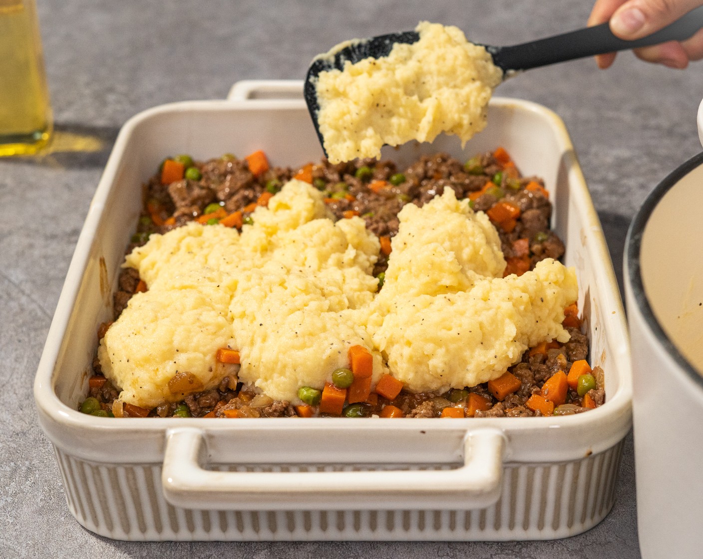 step 10 Transfer the stew mixture to a pie dish. Spread the mashed potatoes over the top. And use a fork to drag the tines over the top of the mash to get crispy bits.