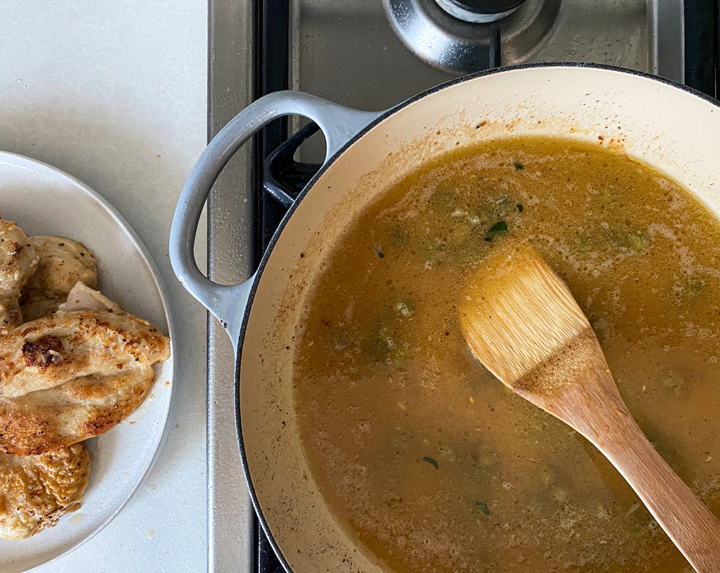 step 6 Add the remaining butter and the garlic and simmer briefly. Stir in the reserved flour, followed by the Chicken Broth (1 1/2 cups), lemon juice, half of the zest, and 3/4 of the Capers (3 Tbsp). Stir continuously until smooth and the liquid starts to boil.