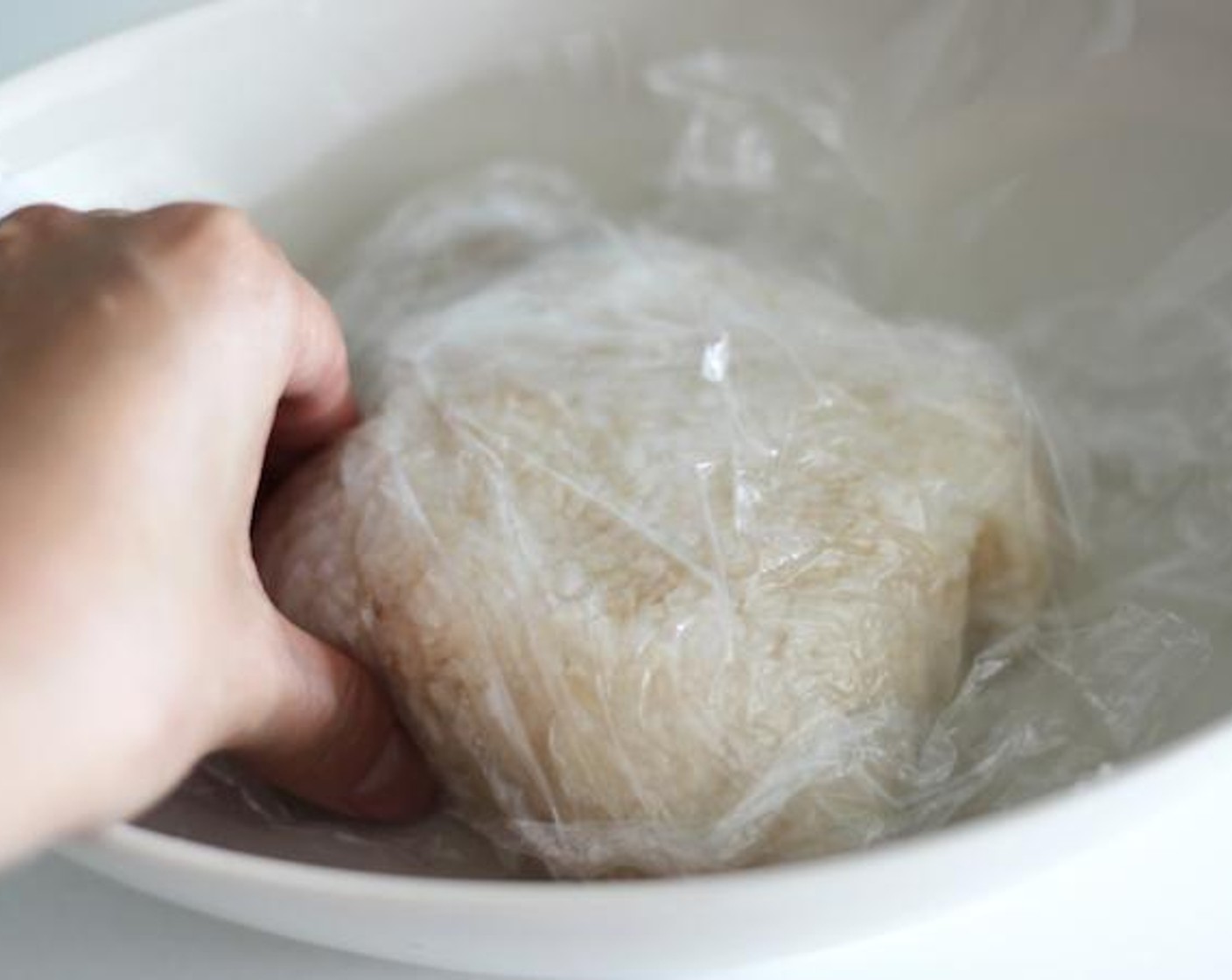 step 1 Take preferred amount of cooked White Rice (1/3 cup) on a plate and start making the shape into Yubaba’s face. I recommend you use plastic wrap for easier crafting.