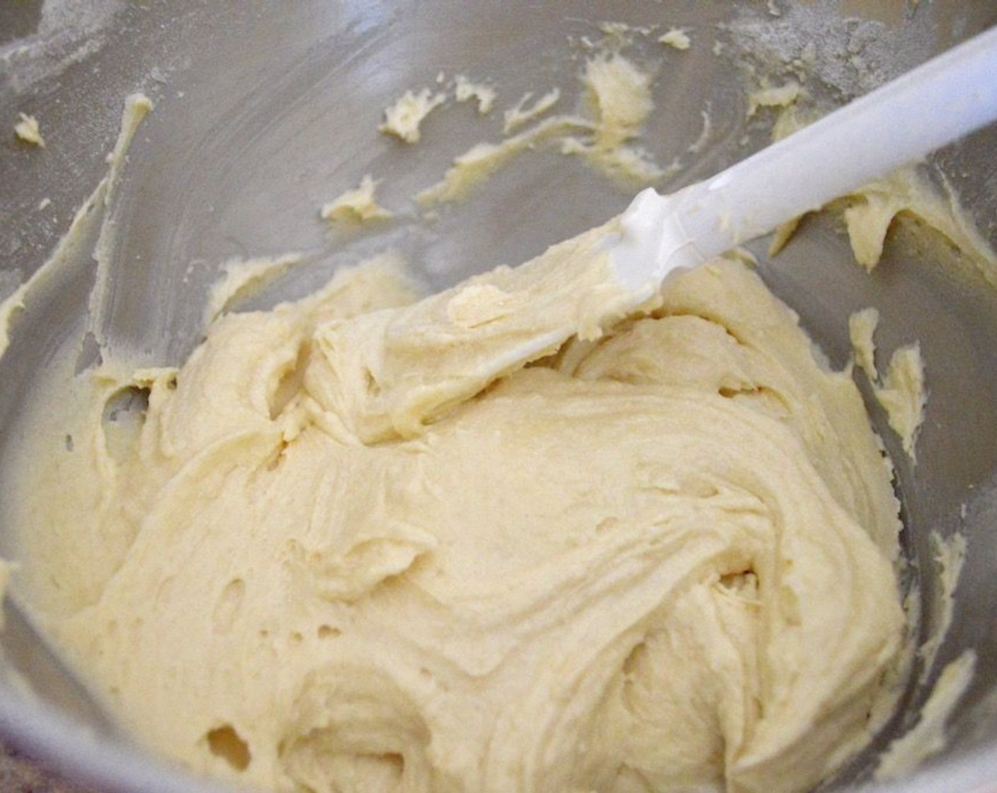 step 3 Then, set up a stand mixer with a paddle attachment and beat the Butter (1 cup) and Granulated Sugar (1 cup) together in its bowl. Add the Eggs (4) one at a time, pushing down the sides as you add them in. Finally, add 1/3 of the dry ingredients followed by the Milk (1/4 cup). Repeat this again, and then end with the final 1/3 of the dry ingredients.