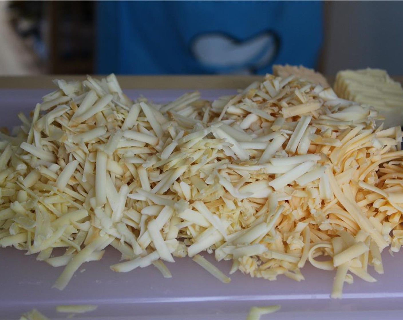 step 8 Grate the Smoked Gruyere Cheese (2 cups), Aged White Cheddar (2 cups), and Gouda (1 1/4 cups).