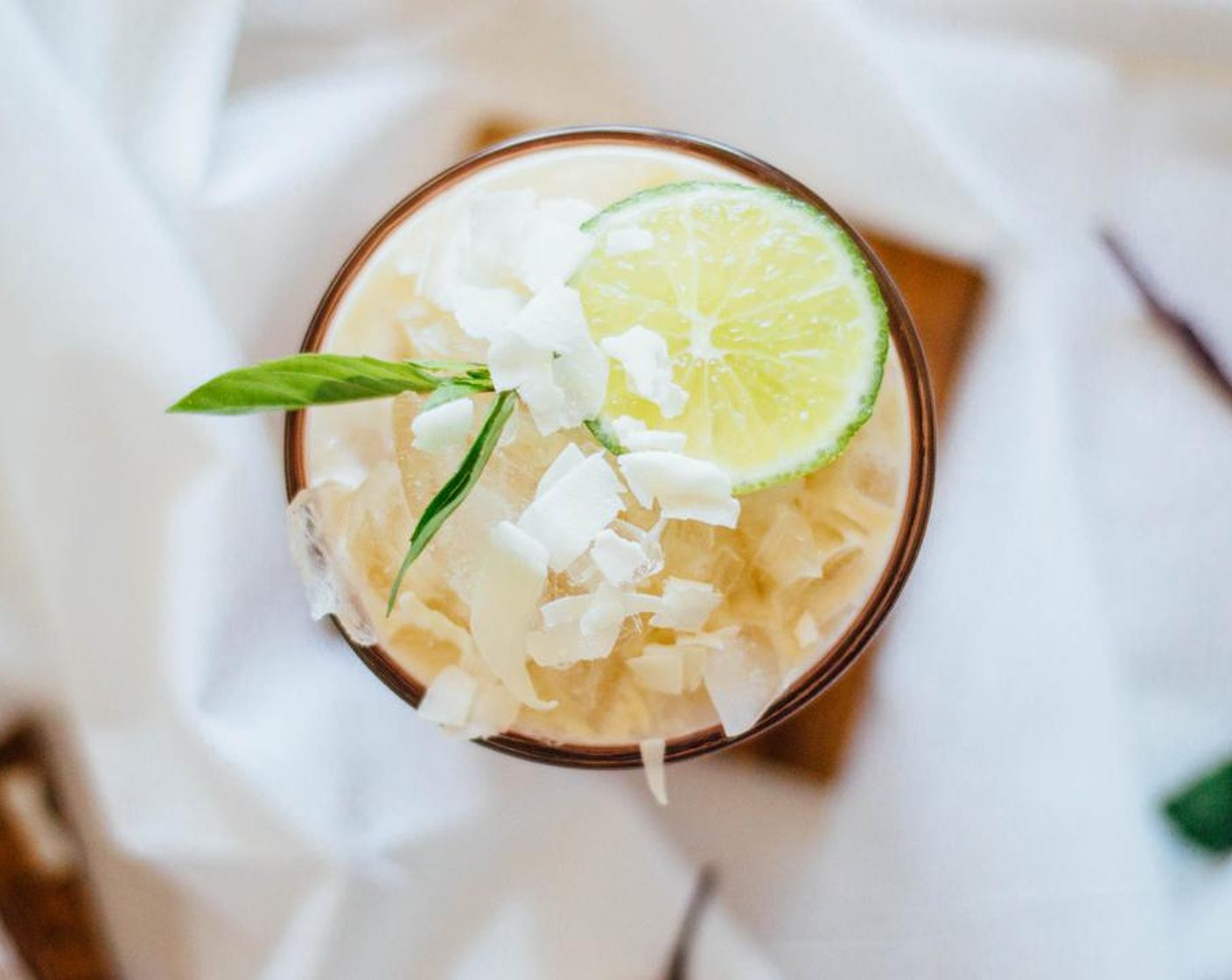 step 3 Strain over ice. Add crushed ice on top and garnish with slices of Limes (2 slices) and Unsweetened Shredded Coconut (to taste). Serve and enjoy!