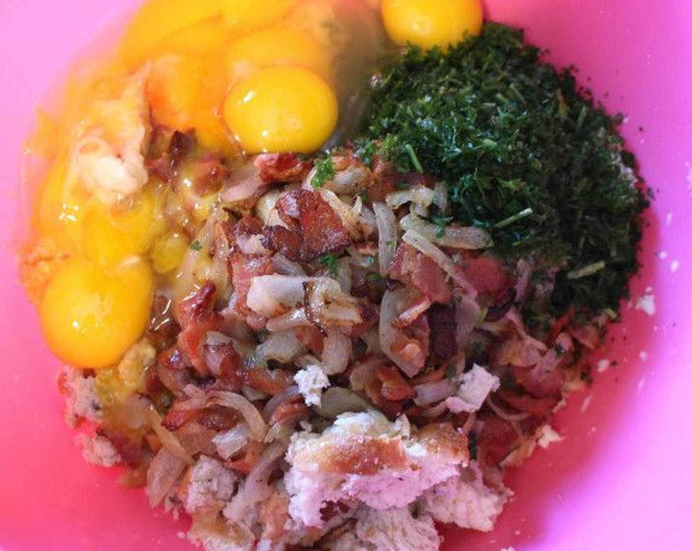 step 9 Return the bread to the bowl, add the bacon and onions, Fresh Parsley (1 cup), the yolks of 4 Eggland's Best Classic Eggs (4), 2 whole Eggland's Best Classic Eggs (2), kosher salt, Ground Nutmeg (to taste) and Ground White Pepper (to taste) to taste.