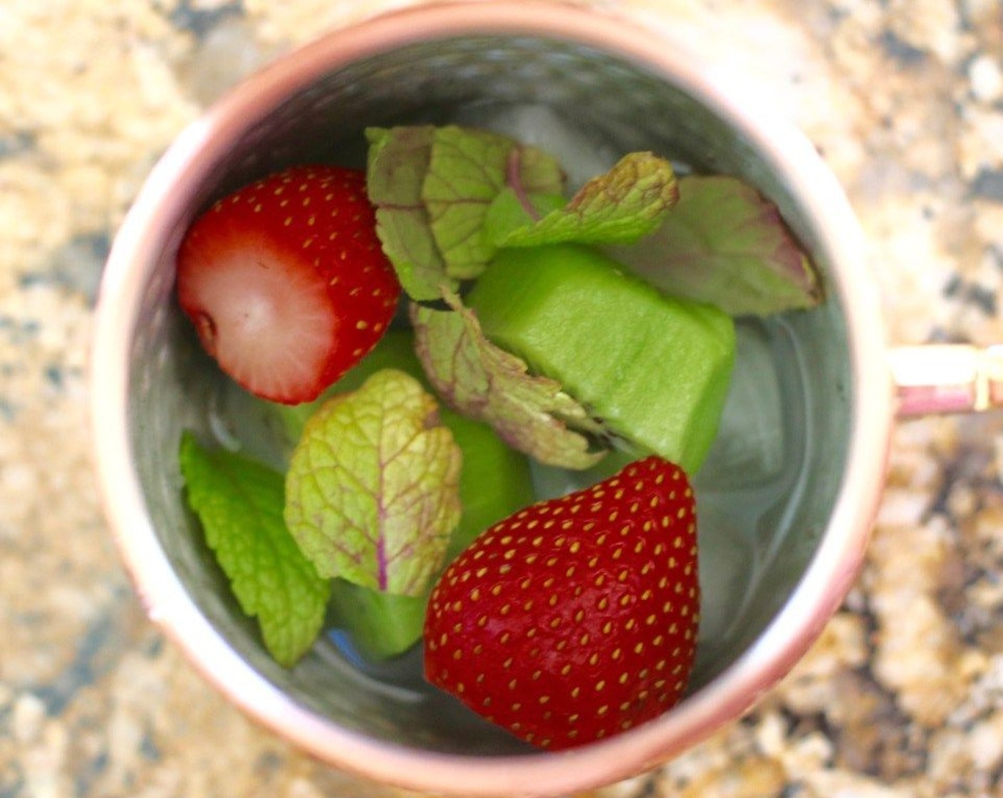 step 3 Add 1 Kiwifruit (2), 2 Fresh Strawberries (4), and approximately 5 Fresh Mint Leaves (10) leaves per cup, then muddle well.