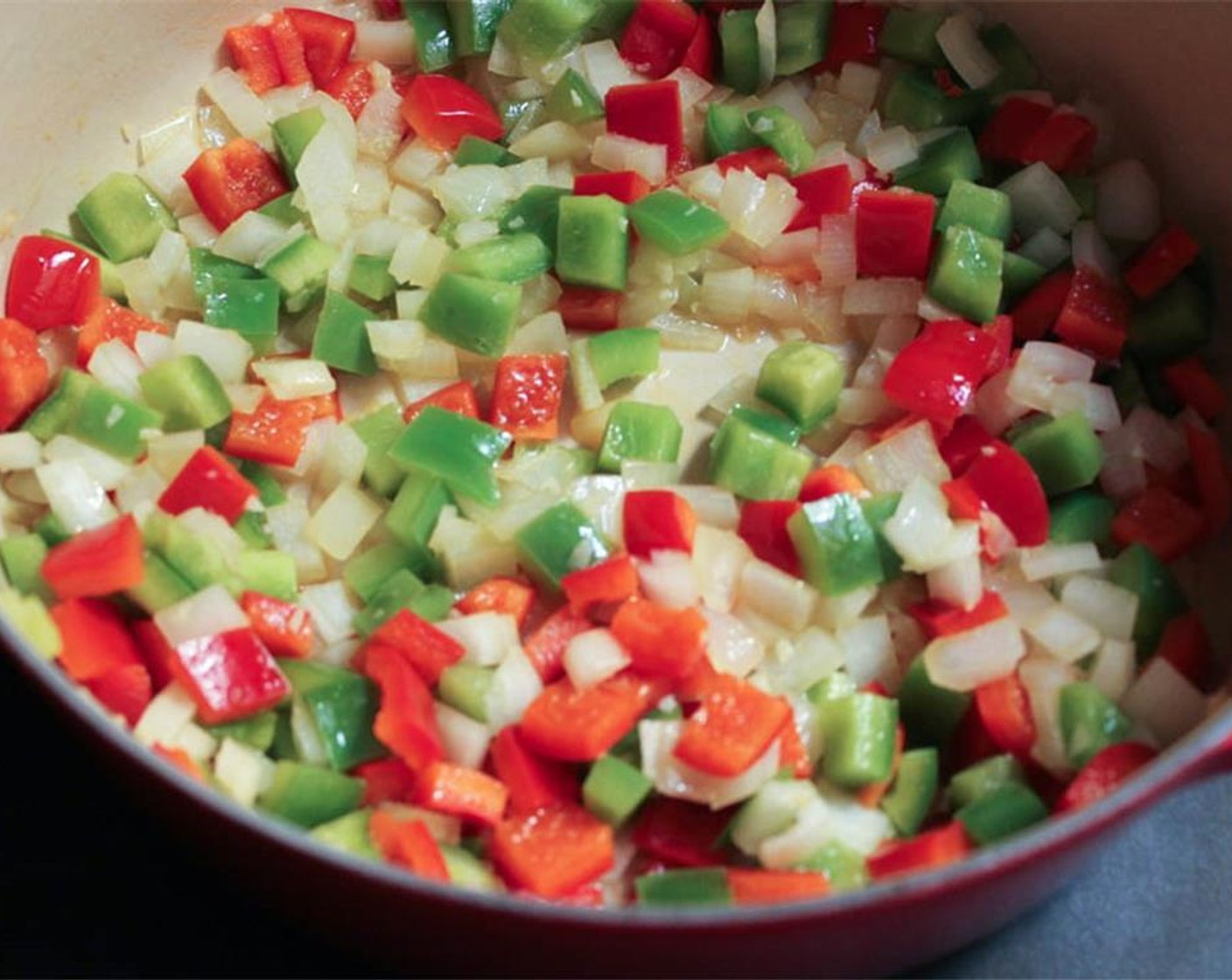 step 1 Heat Olive Oil (1 Tbsp)  in a Dutch oven or large pot. Add the Red Bell Pepper (1), Green Bell Pepper (1), Yellow Onion (1/2), and Garlic (2 cloves). Sauté for about 5 minutes, until the peppers soften and the onions become translucent.