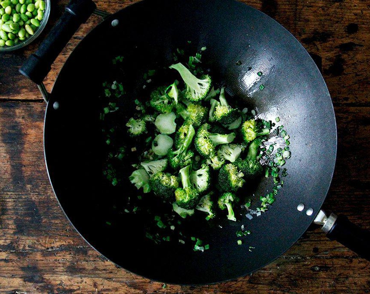 step 2 Heat the Neutral Oil (2 Tbsp) in a large skillet over medium-high heat. Add the green and white part of the Scallion (1 bunch) and cook, stirring frequently, for two to three minutes, or until tender. Add the Broccoli (1 head), season with Soy Sauce (1 Tbsp), and cook, stirring occasionally, for two to three minutes, until the bok choy is bright green and tender.