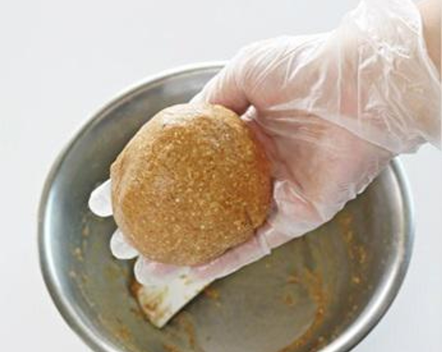 step 1 To make the mooncake skin, combine Old Fashioned Rolled Oats (2/3 cup), Multigrain Flour (1/2 cup), Vegetable Oil (1 tsp), and Water (3 1/3 Tbsp) together in a boil. Knead well to form a dough and divide in 10-12 small balls.