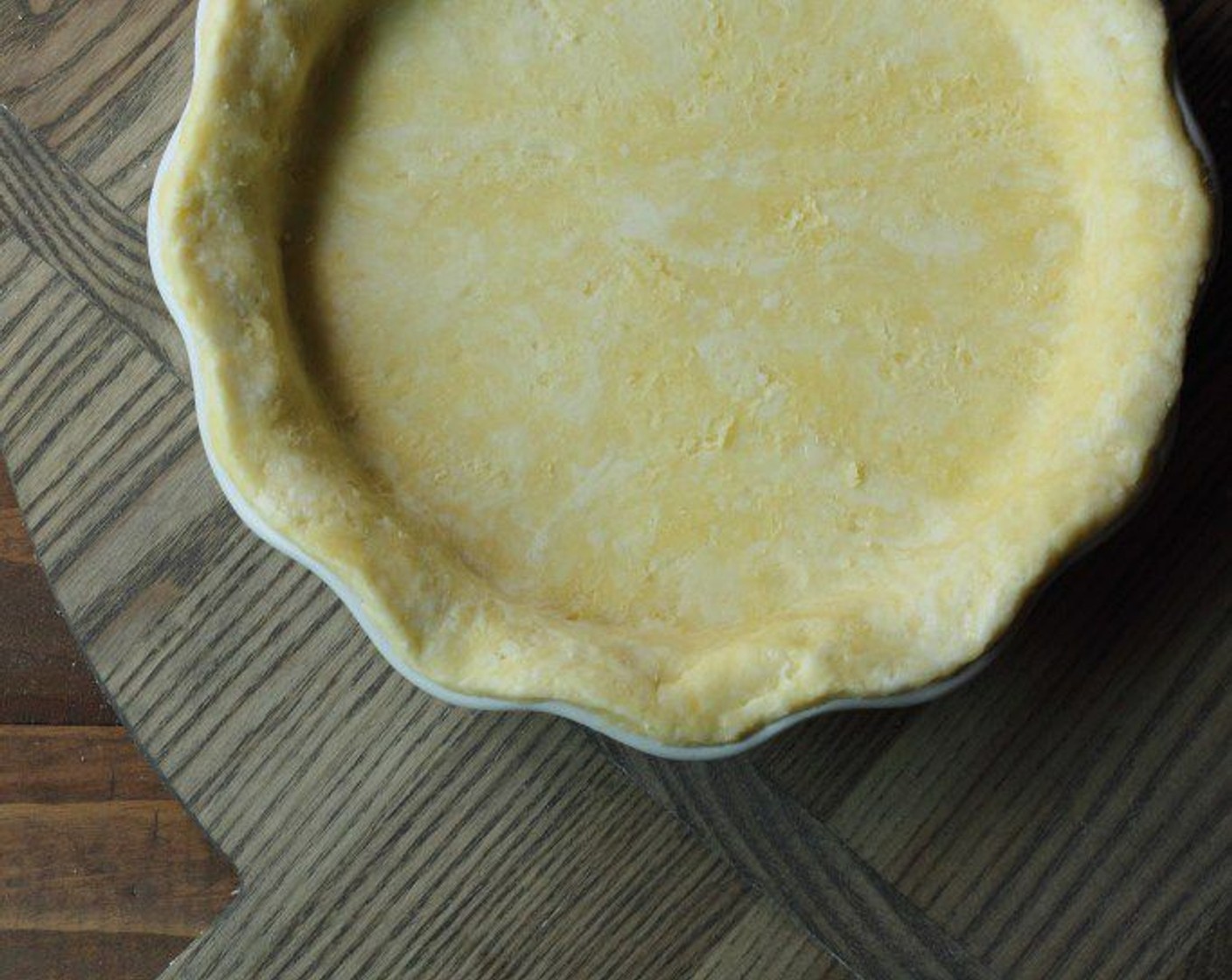 step 16 Once the dough is a uniform thickness, about 11 inches in diameter, remove top parchment paper and place the dough over your 9inch pie plate, raw dough side down.