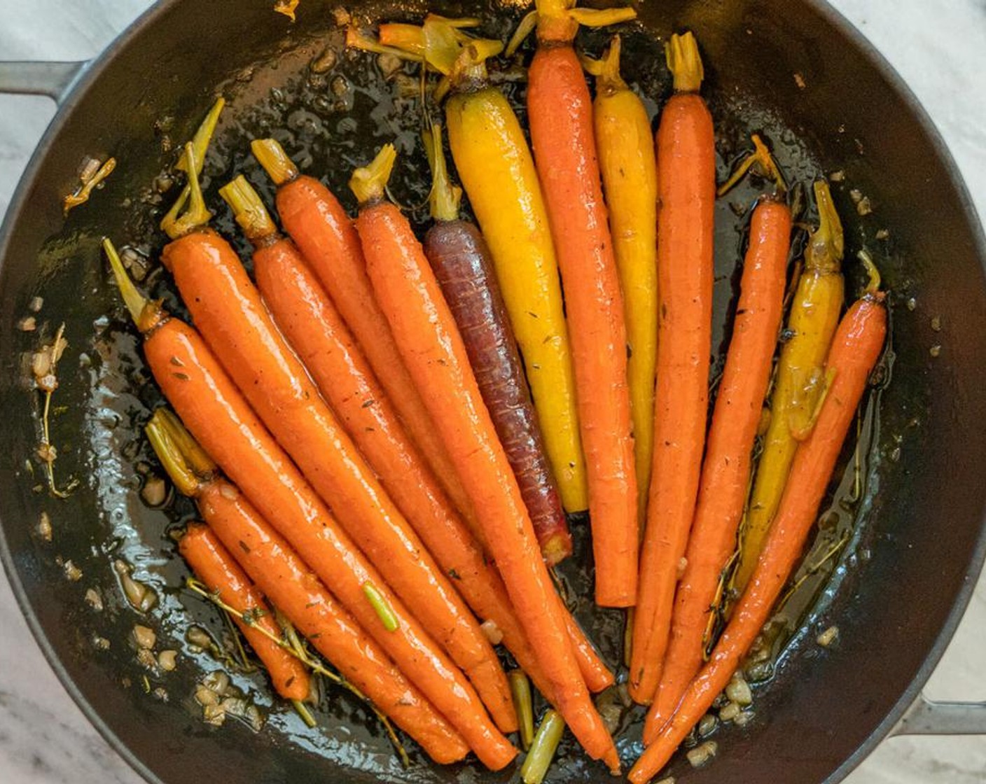 step 4 Sprinkle with Sea Salt (1 pinch) and Ground Black Pepper (1 pinch), if using. Jiggle the pan around to get the carrots coated. Add a splash of water if necessary if the liquid is drying up too quick.