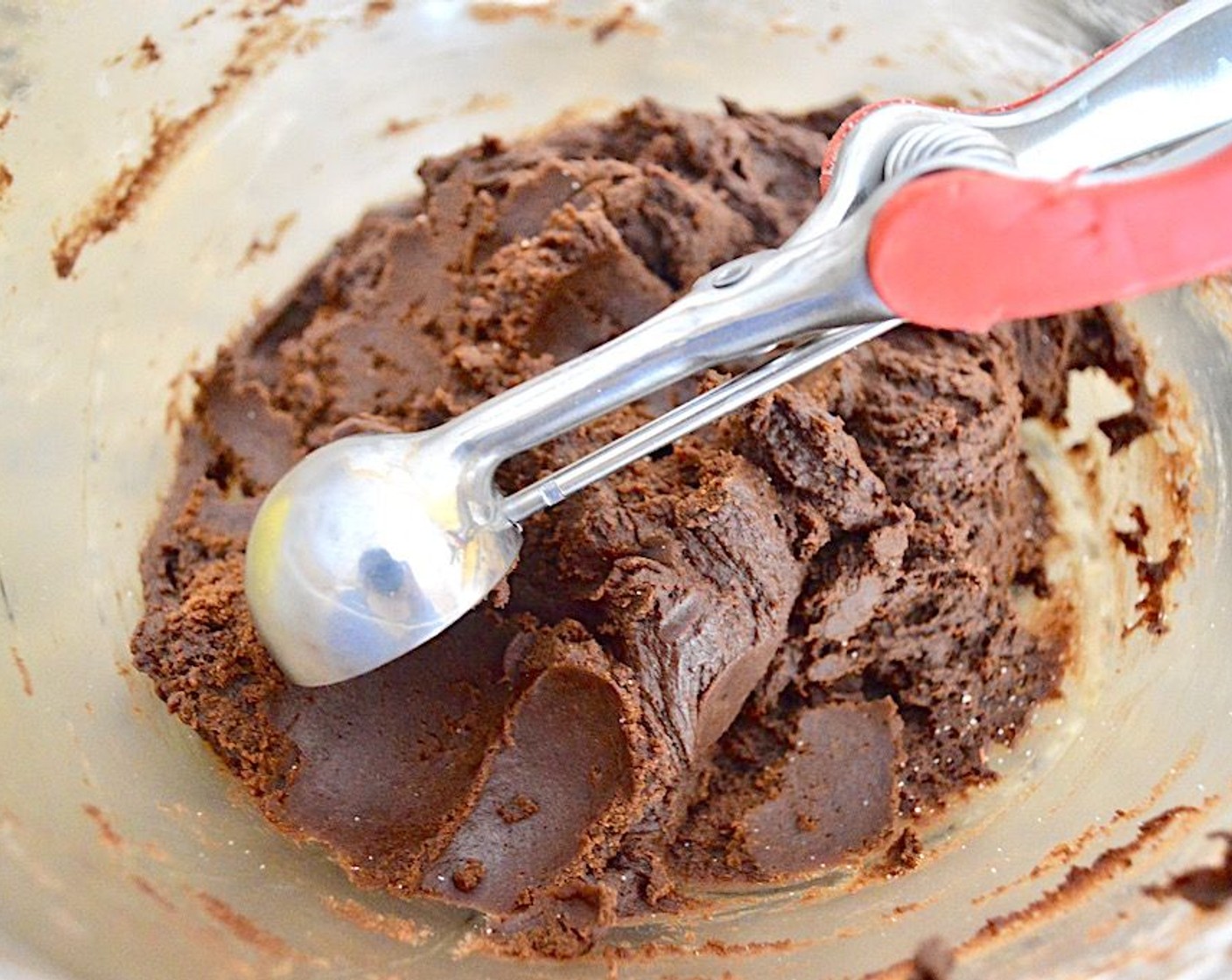 step 6 Use a 1 1/2-inch cookie scoop to scoop a perfect mound of the dough and smooth it out into a ball. Roll it in the Granulated Sugar (1/2 cup) and place it on the sheet tray. Repeat until the dough is gone, you should get 24 cookies with 12 on each tray.